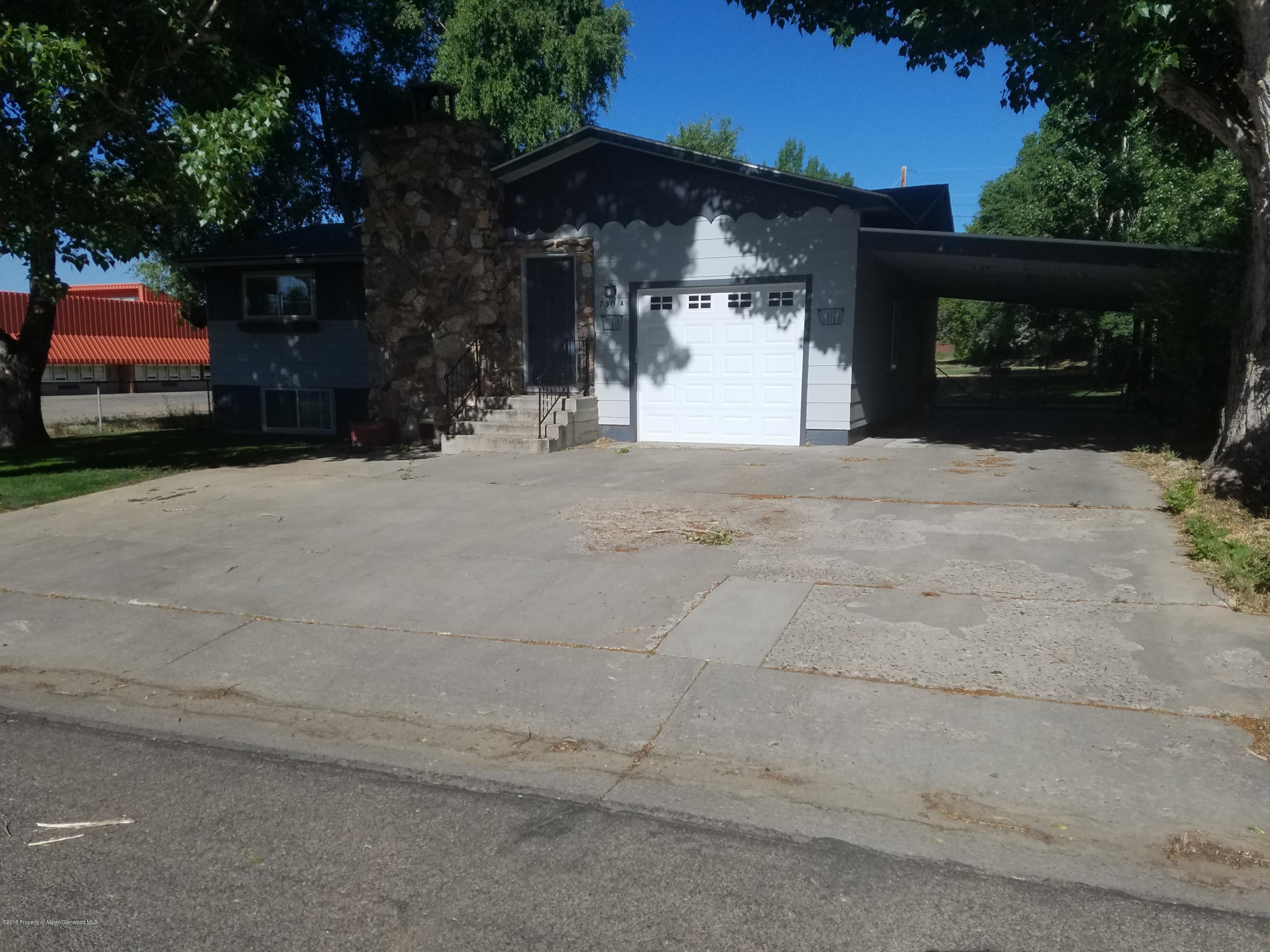 730 Green Street Craig, CO 81625 - Photo 3 of 34 a view of a house with a yard and garage