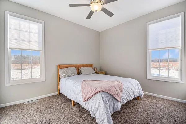 a bedroom with a bed and window