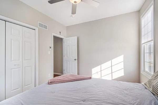 a bedroom with a bed and a window