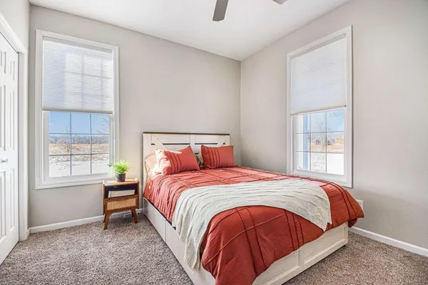 a bedroom with a bed and window