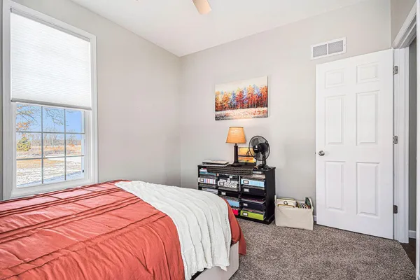 a bedroom with a bed and a view of bedroom