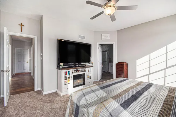 a bedroom with a bed and a flat screen tv
