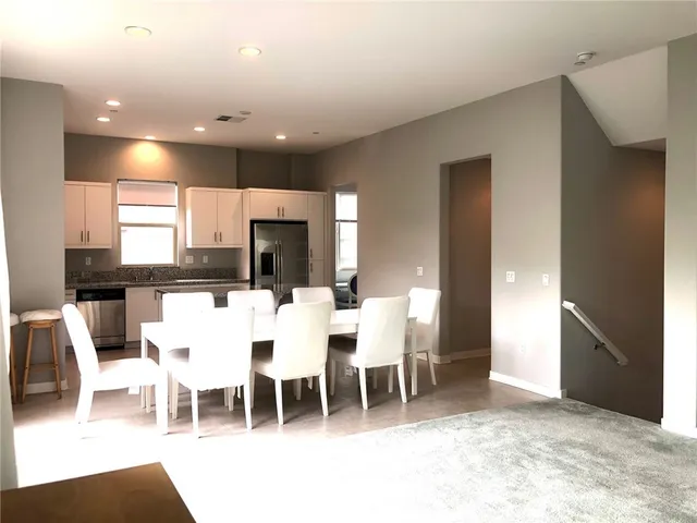 a large kitchen with a table and chairs
