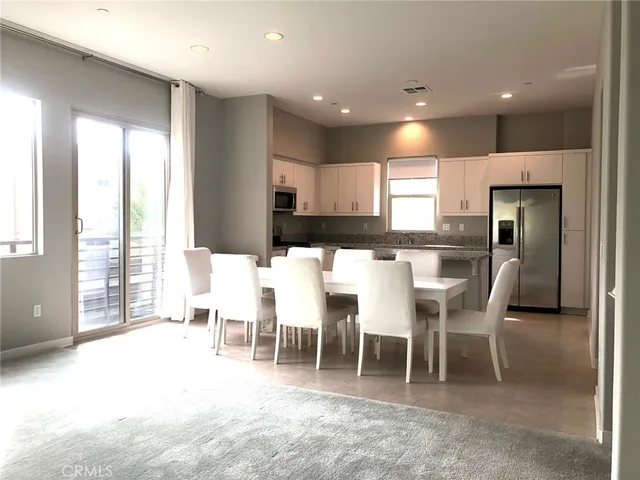 a kitchen with stainless steel appliances granite countertop a sink a stove and a refrigerator