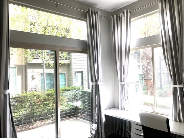 a room with a large window and dining room