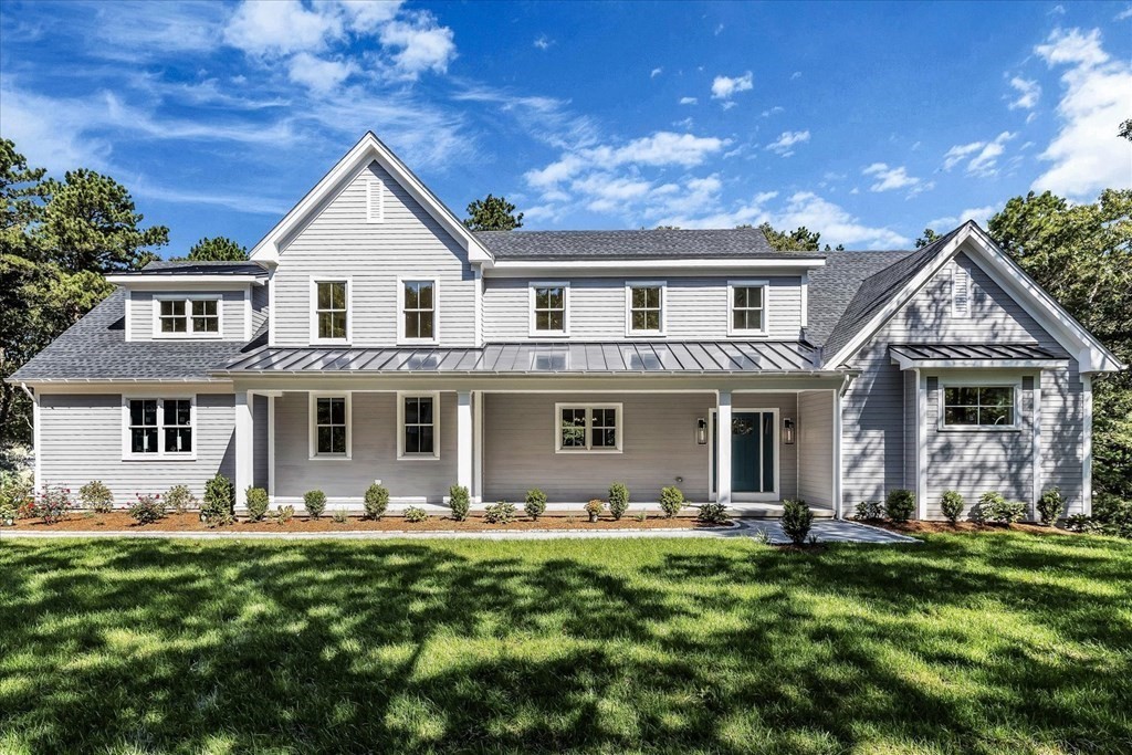 58 Amos Landing Road Mashpee, MA 02649 - Photo 1 of 42 a front view of a house with a yard