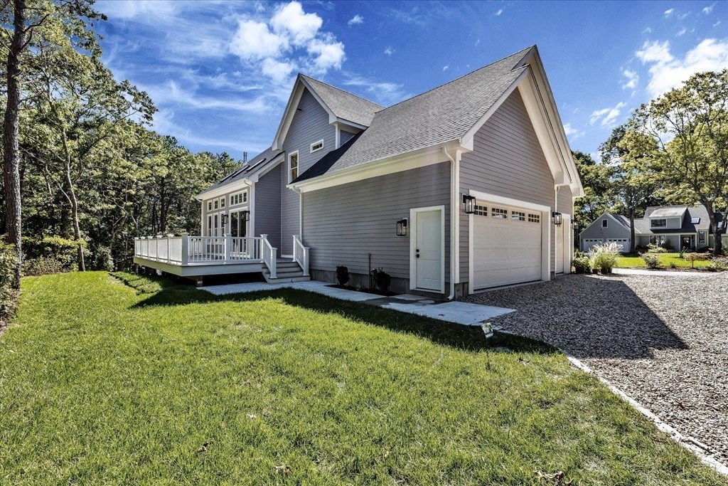58 Amos Landing Road Mashpee, MA 02649 - Photo 11 of 42 a view of house with backyard and sitting area