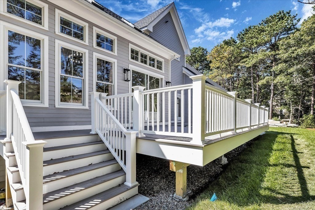 58 Amos Landing Road Mashpee, MA 02649 - Photo 13 of 42 a view of a house with backyard and deck
