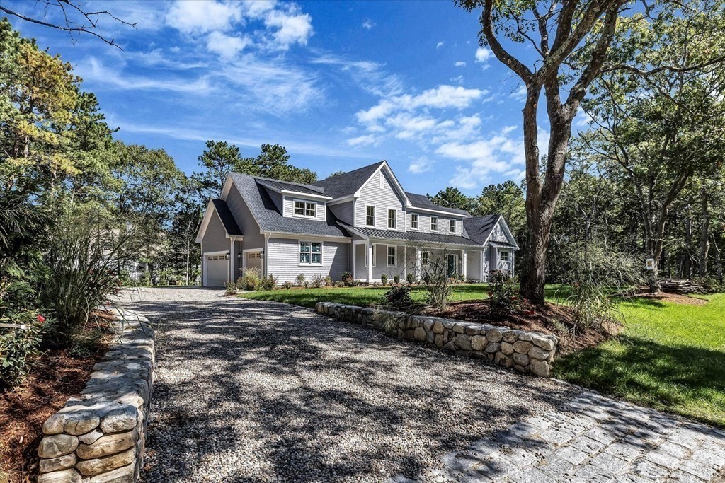 58 Amos Landing Road Mashpee, MA 02649 - Photo 2 of 42 a view of a big house with a big yard and large trees