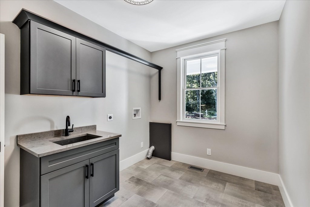 58 Amos Landing Road Mashpee, MA 02649 - Photo 25 of 42 a kitchen with a sink cabinets and a window