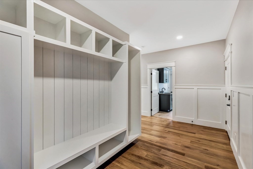 58 Amos Landing Road Mashpee, MA 02649 - Photo 26 of 42 a view of a hallway with wooden floor and cabinet