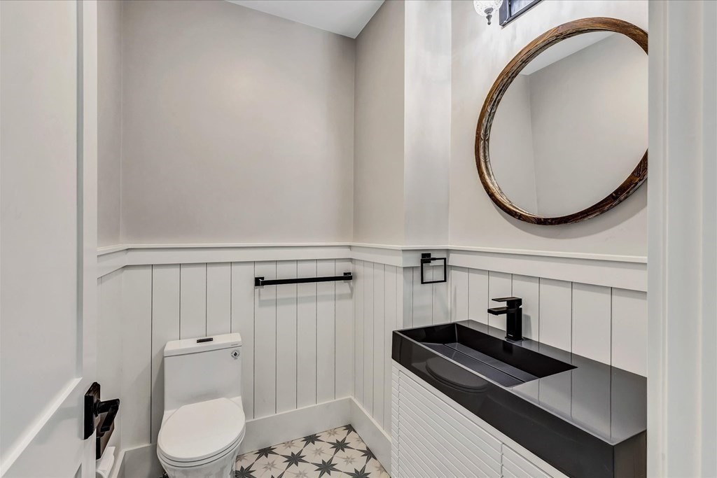 58 Amos Landing Road Mashpee, MA 02649 - Photo 27 of 42 a bathroom with a sink a toilet and a mirror