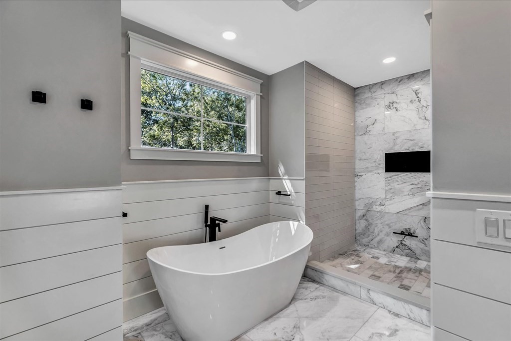58 Amos Landing Road Mashpee, MA 02649 - Photo 30 of 42 a white bath tub sitting in a bathroom and mirror