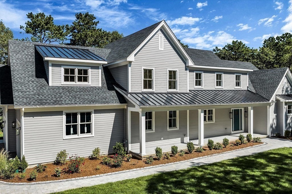 58 Amos Landing Road Mashpee, MA 02649 - Photo 3 of 42 a front view of a house with a yard
