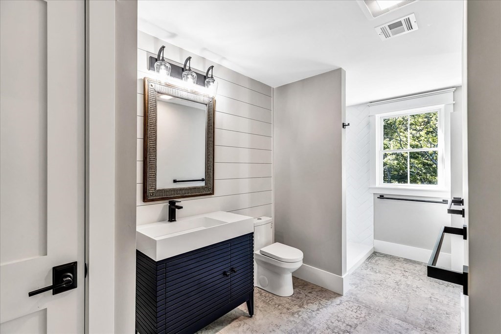 58 Amos Landing Road Mashpee, MA 02649 - Photo 36 of 42 a bathroom with a sink a toilet and mirror