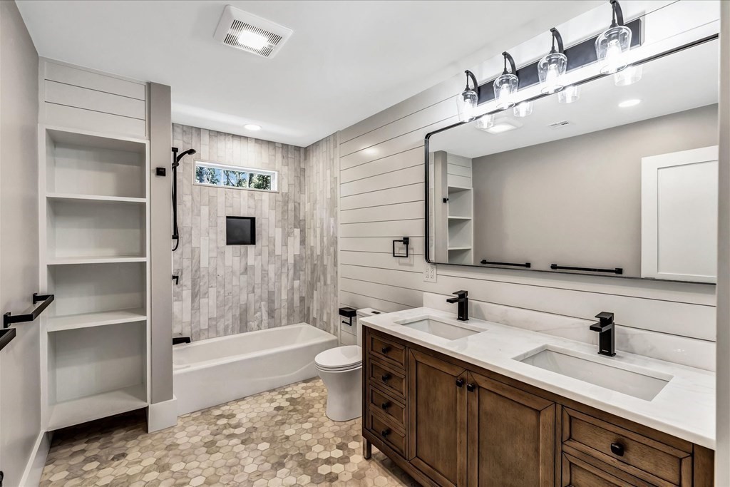 58 Amos Landing Road Mashpee, MA 02649 - Photo 38 of 42 a bathroom with a tub sink and mirror