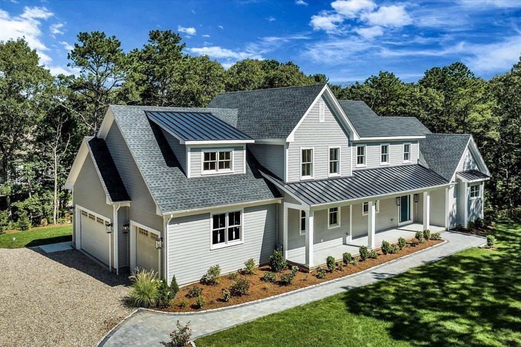 58 Amos Landing Road Mashpee, MA 02649 - Photo 4 of 42 a front view of a house with a yard