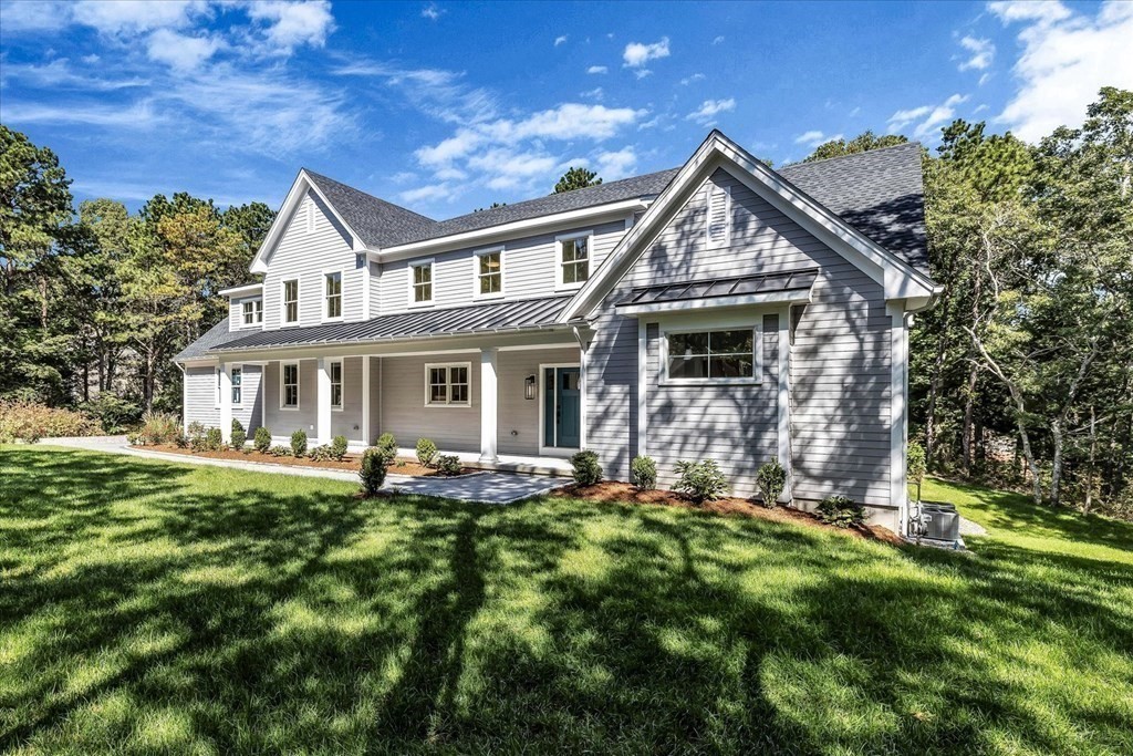 58 Amos Landing Road Mashpee, MA 02649 - Photo 7 of 42 a front view of house with a garden and plants