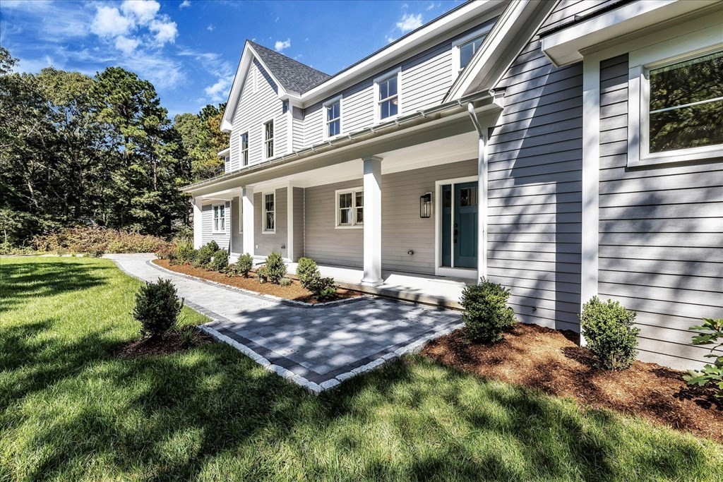 58 Amos Landing Road Mashpee, MA 02649 - Photo 8 of 42 a view of a house with a yard and plants
