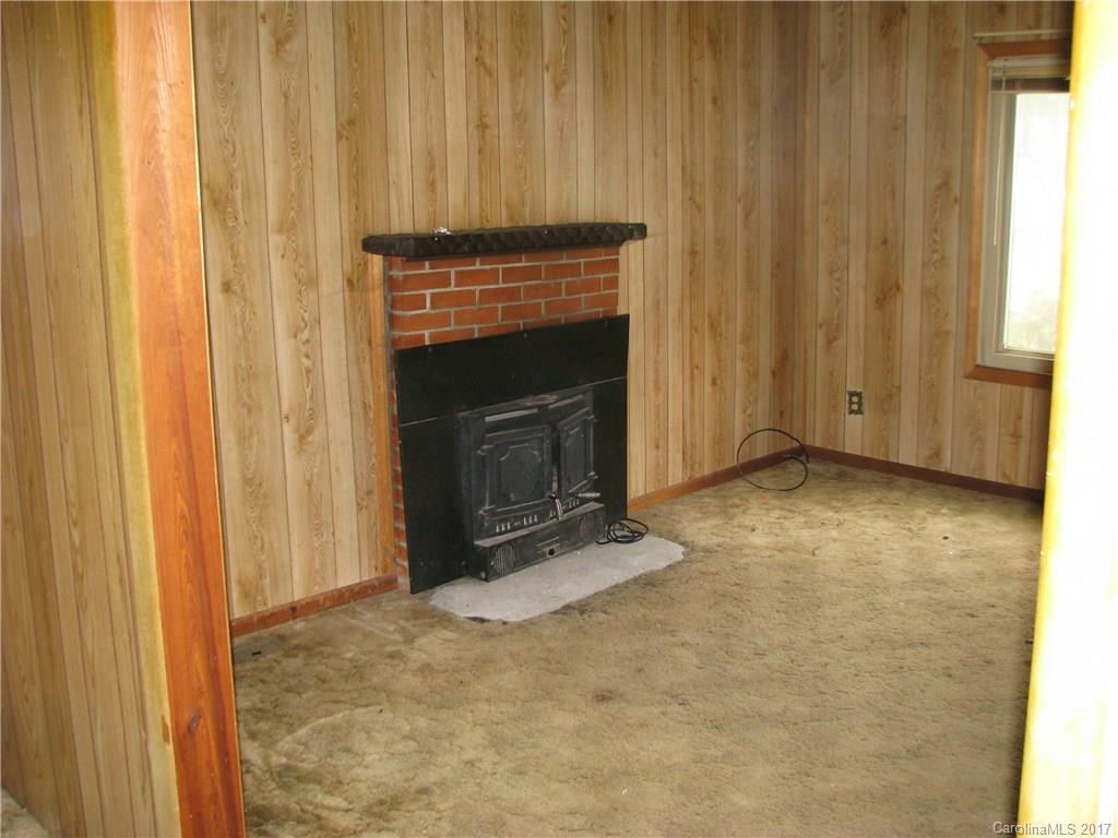 2075 Pinckney Road Chester, SC 29706 - Photo 5 of 18 a view of an empty room with a fireplace and a window