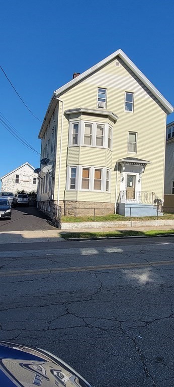 1010 Middle Street Fall River, MA 02721 - Photo 2 of 25 a front view of a residential apartment building with a yard