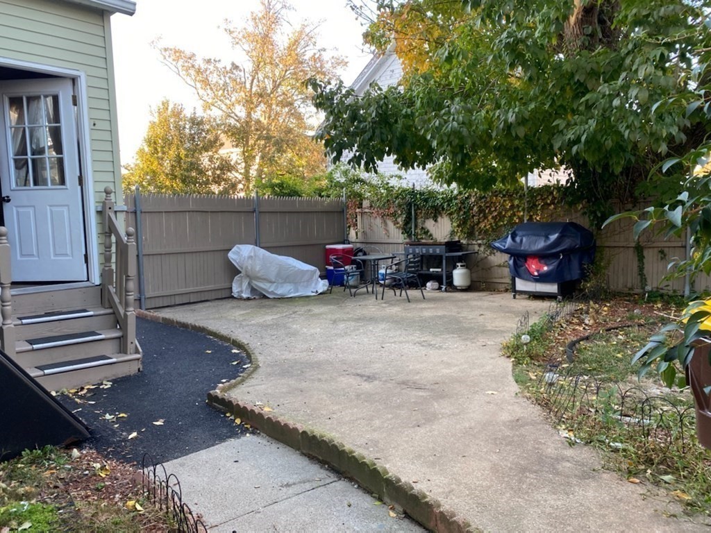 1010 Middle Street Fall River, MA 02721 - Photo 7 of 25 a backyard of a house with fire pit and outdoor seating