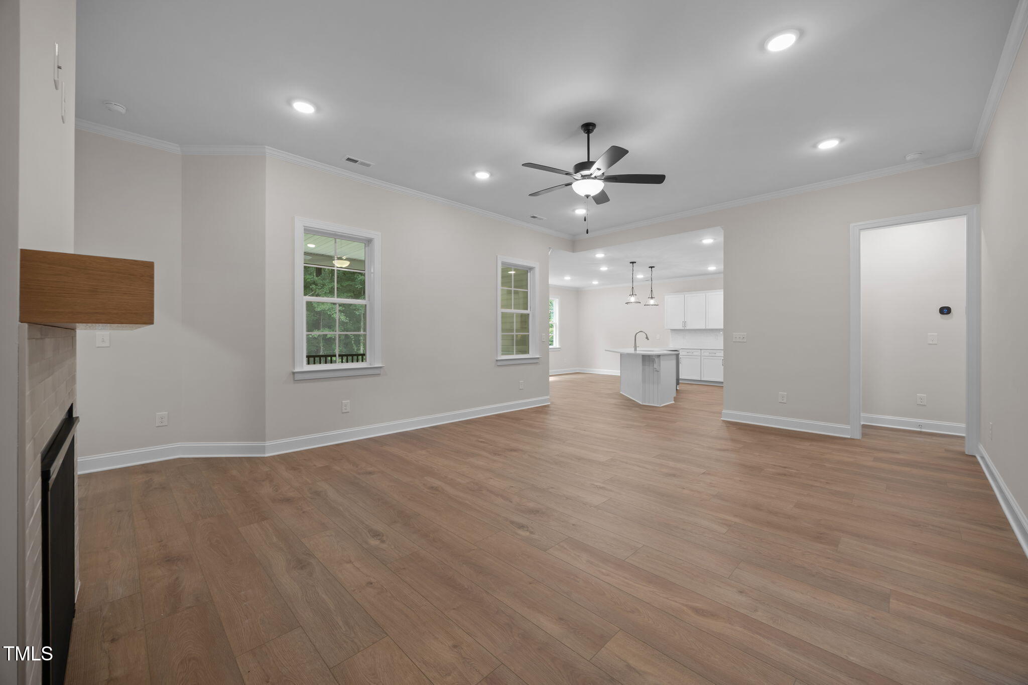 109 Drew Street Louisburg, NC 27549 - Photo 11 of 30 a view of an empty room with a window and wooden floor