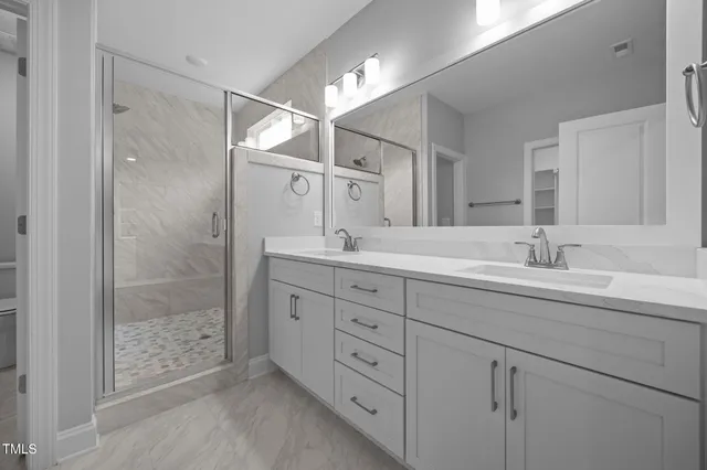 a spacious bathroom with double sink and a mirror