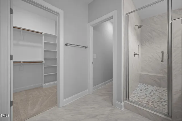 a bathroom with a glass shower door