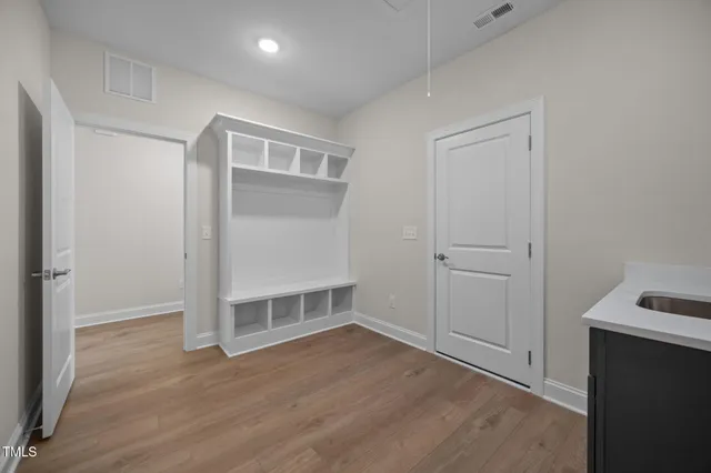 an empty room with wooden floor