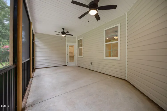 a view of a livingroom with a ceiling fan and window