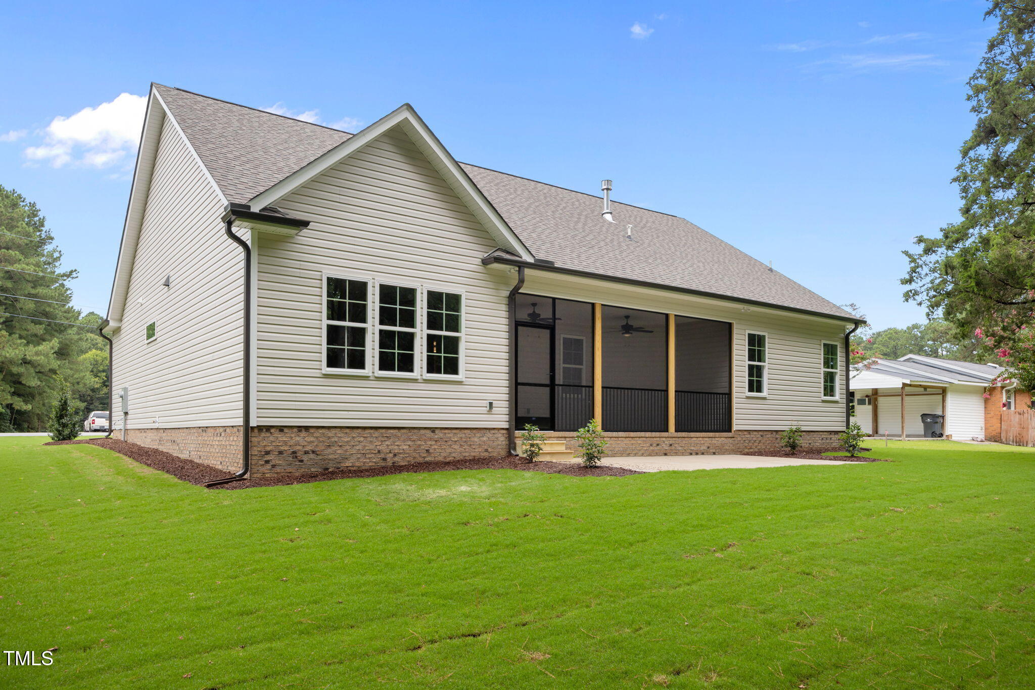 109 Drew Street Louisburg, NC 27549 - Photo 28 of 30 a front view of house with a garden and trees