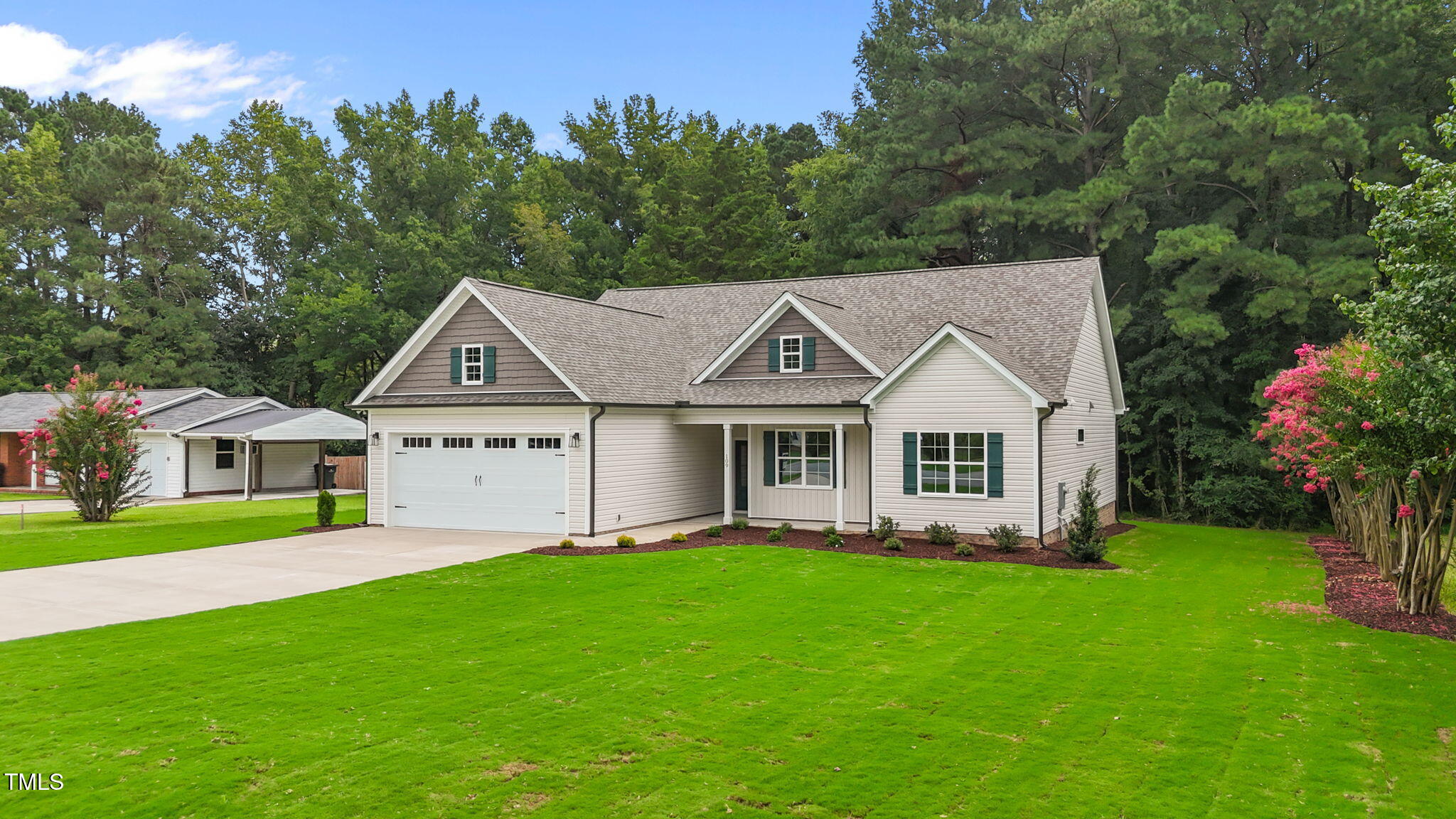 109 Drew Street Louisburg, NC 27549 - Photo 29 of 30 a front view of a house with a garden and trees