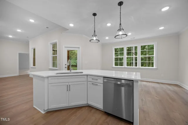 a kitchen with a sink stove and wooden cabinets