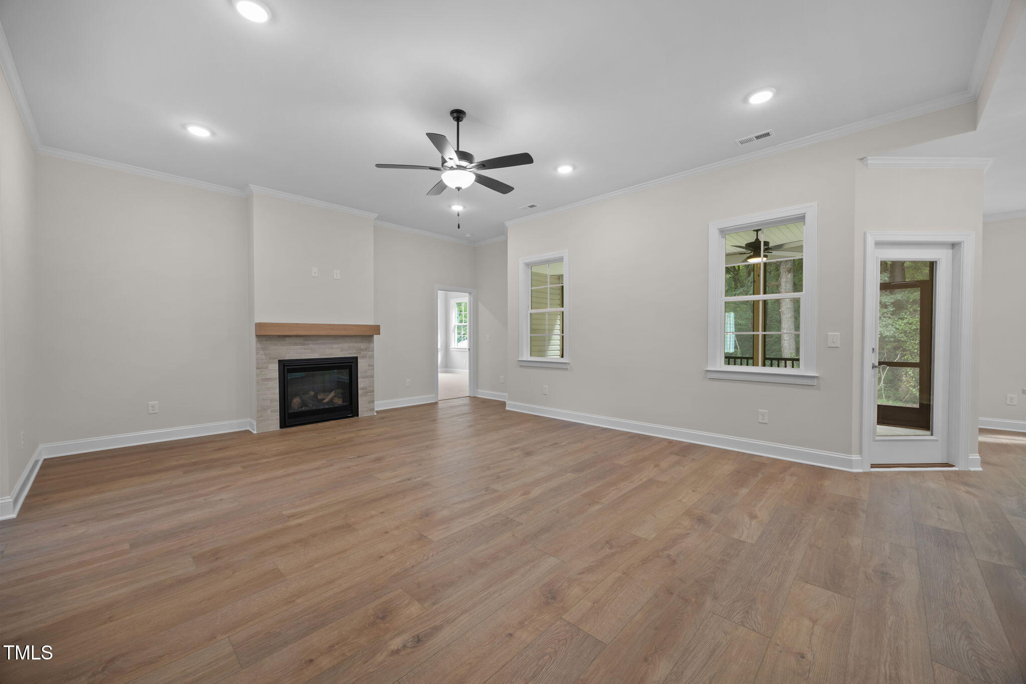 109 Drew Street Louisburg, NC 27549 - Photo 9 of 30 an empty room with windows and a fireplace