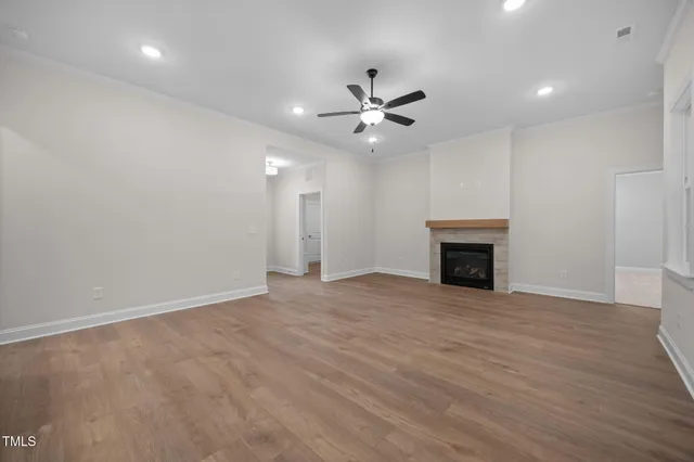 an empty room with fan and windows