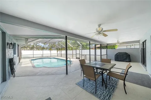 a dining room with furniture and a floor to ceiling window