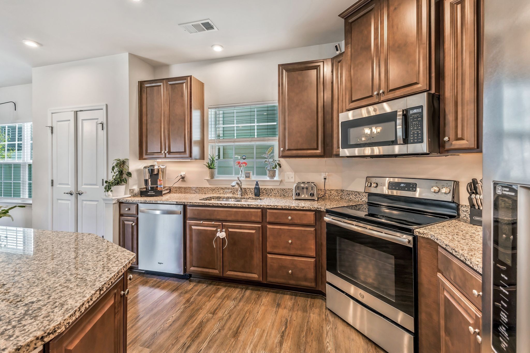 3793 Pin Hook Road Antioch, TN 37013 - Photo 6 of 30 a kitchen with stainless steel appliances granite countertop hardwood floor sink stove and granite counter top