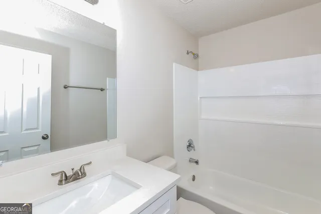 a bathroom with a bathtub and a sink