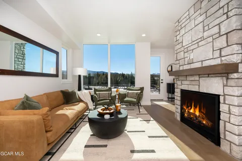 a living room with furniture a fireplace and a window