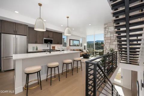 a kitchen with kitchen island a large counter top space appliances and cabinets