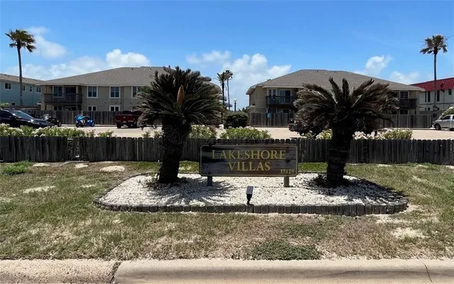 a view of a house with backyard water fountain and sitting area