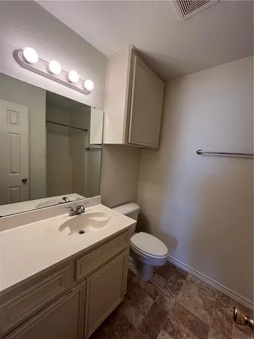 a bathroom with a sink a toilet a mirror and shower