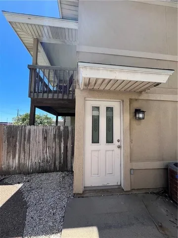 a view of a house with a wooden deck