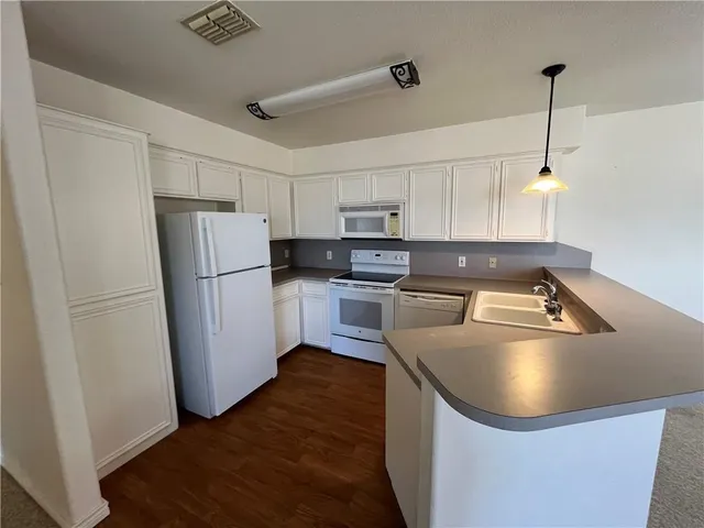 a kitchen with a refrigerator a sink and dishwasher