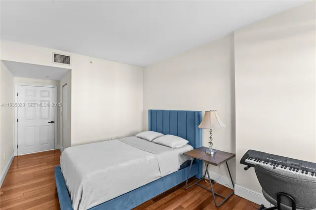 a bed room with a bed and a chair