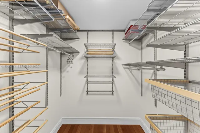 a view of walk in closet with empty racks