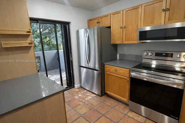 a kitchen with stainless steel appliances granite countertop a refrigerator stove and sink