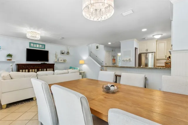 a kitchen with stainless steel appliances kitchen island a stove a sink dishwasher and white cabinets with wooden floor