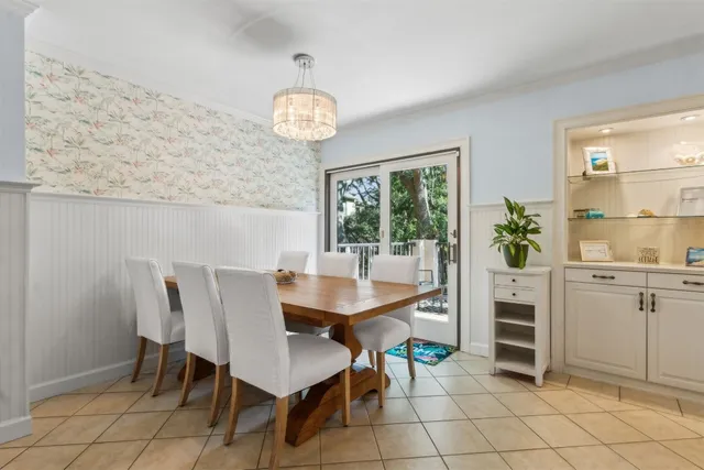 a view of a dining room with furniture and a chandelier